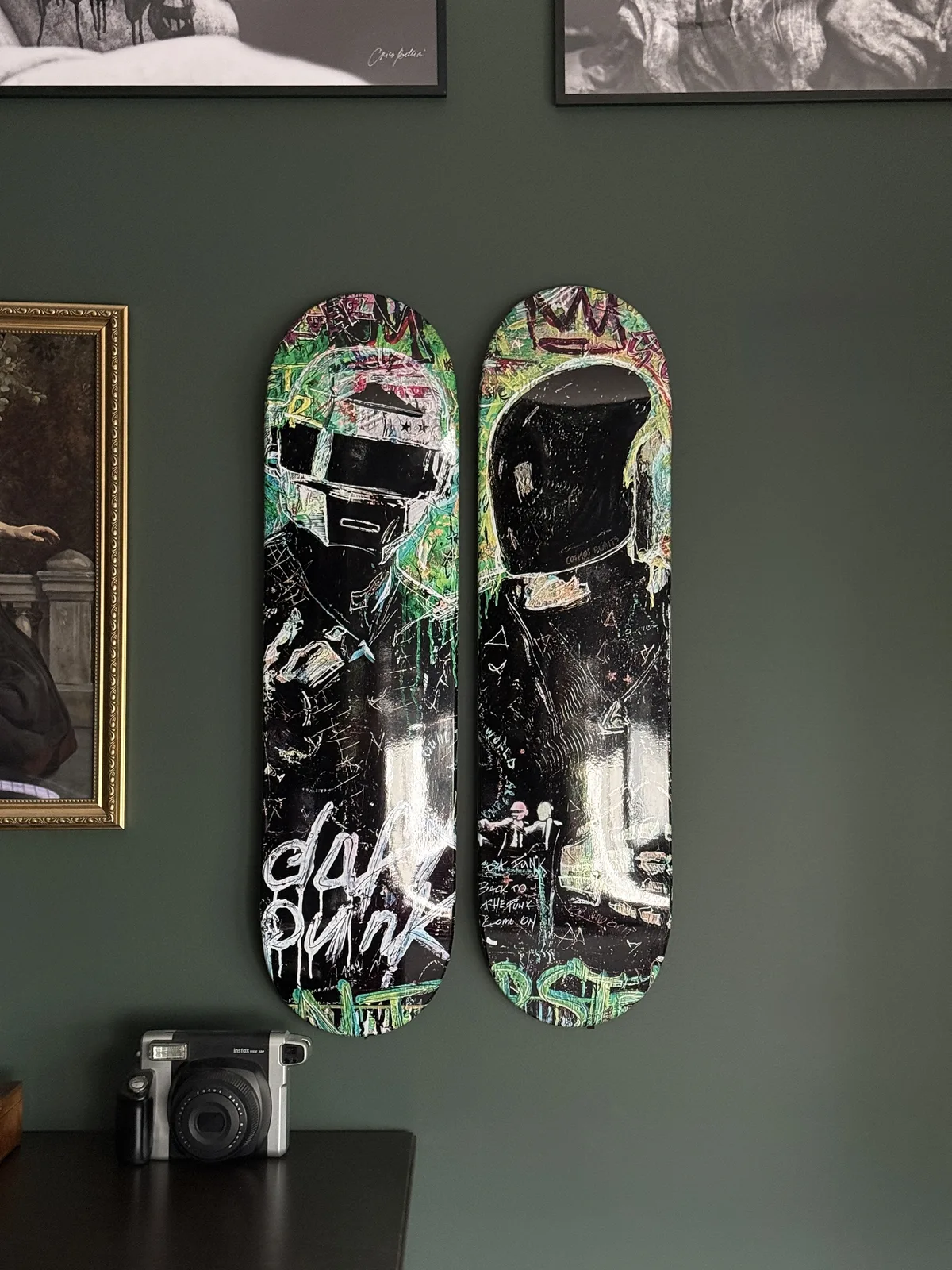 POPART'URAS artwork printed on skateboard decks mounted on a green wall